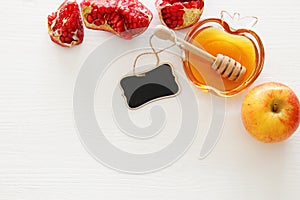 Rosh hashanah jewesh holiday concept - honey, pomegranate and apple traditional holiday symbols