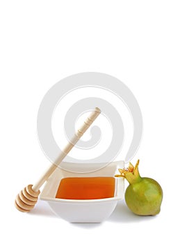 Rosh hashanah (jewesh holiday) concept - honey and pomegranate isolated on white. traditional holiday symbols.