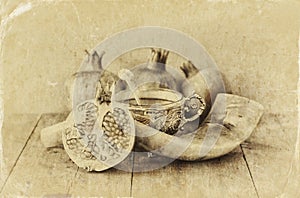 Rosh hashanah (jewesh holiday) concept - shofar, honey, apple and pomegranate over wooden table. traditional holiday symbols.