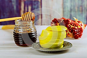 rosh hashanah jewesh holiday concept - shofar, torah book, honey, apple and pomegranate over wooden table