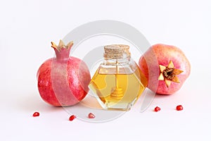 Rosh hashanah (jewish New Year holiday) concept. Pomegranate and honey traditional symbols over white background