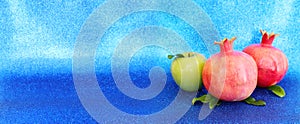 Rosh hashanah (jewish New Year holiday) concept. Taditional symbols over blue glitter background