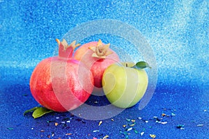 Rosh hashanah (jewish New Year holiday) concept. Taditional symbols over blue glitter background