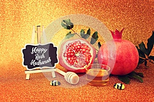 Rosh hashanah (jewish New Year holiday) concept. Taditional symbols over gold glitter background