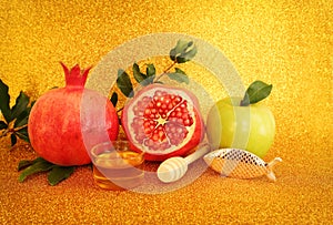 Rosh hashanah (jewish New Year holiday) concept. Taditional symbols over gold glitter background