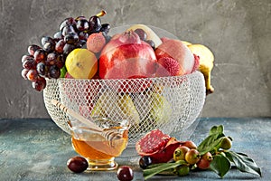 Rosh hashanah - jewish New Year holiday concept. Traditional symbols: Honey jar and fresh apples with pomegranate and basket with