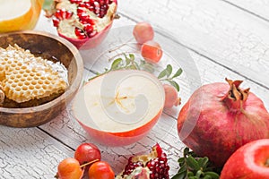 Rosh hashanah - jewish New Year holiday concept. Traditional symbols: Honey jar and fresh apples with pomegranate and shofar -horn