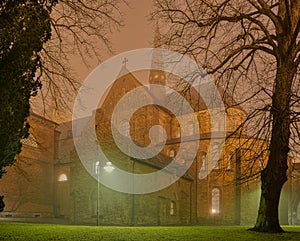 Roskilde Cathedral a misty night, illuminated by streetlamps, Roskilde, Denmark, January 1, 2022