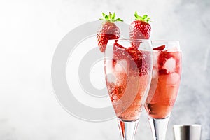 Rossini - italian alcoholic cocktail with sparkling wine, fresh strawberry puree and ice in champagne glasses, copy space,