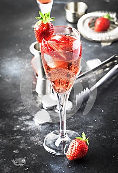 Rossini - italian alcoholic cocktail with sparkling wine, fresh strawberry puree and ice in champagne glasses, copy space,