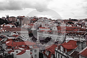 Rossio. Lisbon. Portugal. Red black and white. Sityscape. Old town historic homes. Clouds. Sky.