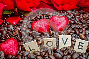 rosted coffee beans with heart chocolates red flowers and LOVE letter