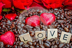 rosted coffee beans with heart chocolates red flowers and LOVE letter photo