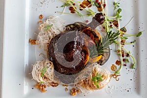 Rosted duck steak on white plate