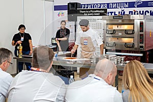 The participant prepares pizza before the competition experts