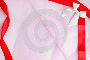 Rosy pink paper texture background with ribbon and bow