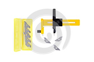 Rotary compass cutter with a set of spare blades isolated on white. Flat lay