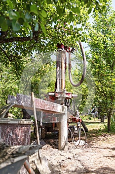 Rotary drilling rig at a construction site.Sludge flow from the joule during the water well drilling