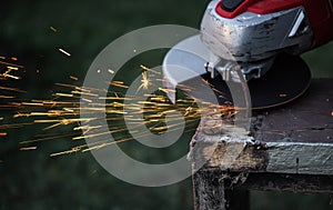 Rotary flex cutter cutting rusty nail on old wooden frame, sparks flying in air, closeup detail