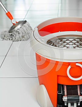 Rotary mop and bucket on tile floor