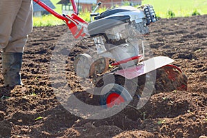 Rotary tiller with plow photo