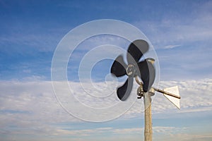 Rotary vane indicates the direction of the wind against the blue sky photo