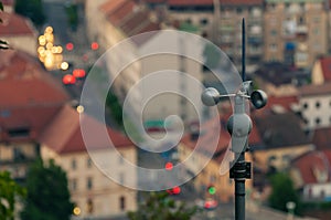 Rotating anemometer measuring wind speed placed on the hill overlooking the city