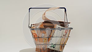 Rotating basket full of money. Basket with euro banknotes.