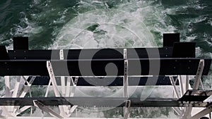 Rotating black paddle wheel of a cruise boat in motion. Slow motion view footage