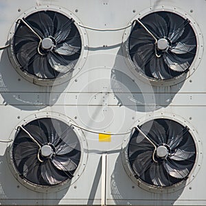 Rotating blades factory fan on the wall of the building