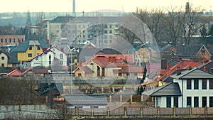 Rotating blades of wind generator for electricity production between residential houses in rural city area.