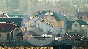 Rotating blades of wind generator for electricity production between residential houses in rural city area.