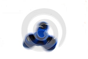 Rotating blue fidget spinner white background