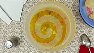 Rotating bowl of vegetable soup on the dinner table