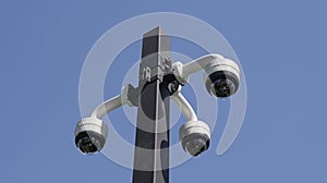 Rotating cctv cameras against blue sky