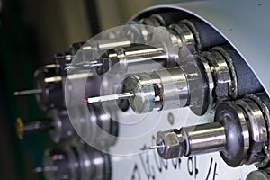 Rotating head with tools at CNC lathe in workshop