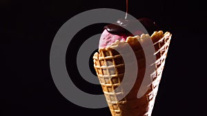 Rotating ice-cream pouring with dark chocolate topping