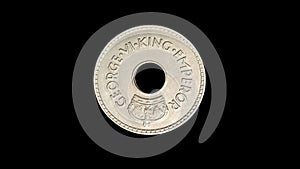 Rotating obverse of Fiji coin 1 penny 1940. Isolated in black background.