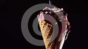 Rotating pink ice cream with chocolate topping