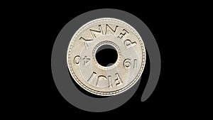 Rotating reverse of Fiji coin 1 penny 1940. Isolated in black background.