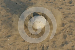 rotating soccer ball on a sand surface