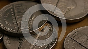 Rotating stock footage shot of American nickles (coin - $0.05)