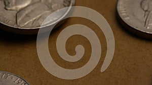 Rotating stock footage shot of American nickles (coin - $0.05)