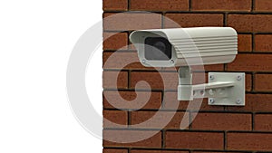 Rotating surveillance camera on brick wall