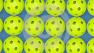 Rotating view of several pickleball balls on court.