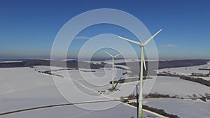 Rotating Wind Wheels in snow-covered winter scenery in Germany