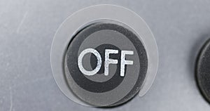 Rotation. Close-up of black button with OFF symbol