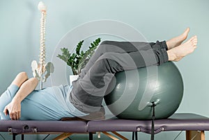 Rotation exercises on the fitness ball in constructive rest position photo