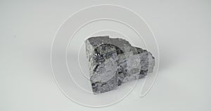 Rotation galena mineral on a white background. Lead ore.