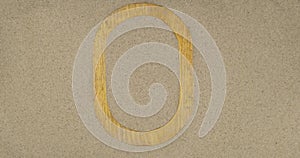 Rotation of an oval wooden frame lying on the sand. Empty space for text and advertising